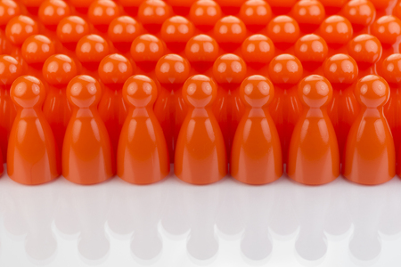 Conceptual orange game pawns as abstract view of a crowdの写真素材