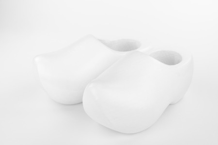 Two traditional Dutch white wooden shoes in a high key recording