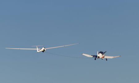 White modern glider which is increased by a small motorized sport airplaneの写真素材