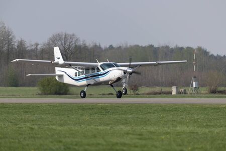 Single-engined propeller business plane during take off at a small airport
