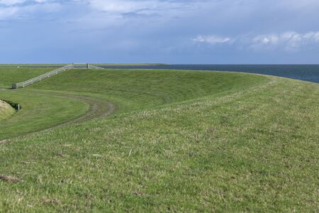 The green sea dike on the Dutch island of Terschelling, in the northern part of the Netherlandsの写真素材