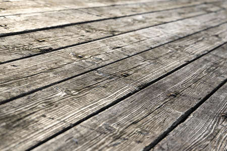 Weathered gray wooden floorboards as background photoの写真素材