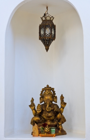 Golden Hindu God Ganesh on the wall white の写真素材