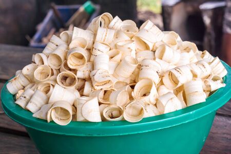 Raw dried ring banana chips in green bowl の写真素材