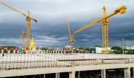 Construction site with crane near building on Cloudy storm background のeditorial素材