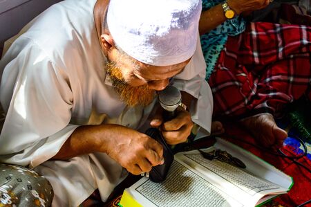 BANGKOK - APRIL 13   Unidentified Leader Musim senior men reading Quran for ceremony in Graduation...