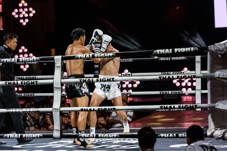 BANGKOK - DECEMBER 24 : P.T.T. Petchrungrueng of Thailand and Sean Kearney of Canada in THAI FIGHT 2016 on December 24, 2016 at Central World, Bangkok, Thailand.のeditorial素材