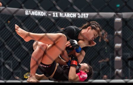 BANGKOK - MARCH 11 : Rika Ishige "Tiny Doll" of Thailand and Audreylaura Boniface of Malaysia in One Championship "One : Warrior Kingdom" on March 11, 2017 at Impact Arena, Muang Thong Thani, Bangkok, Thailandのeditorial素材