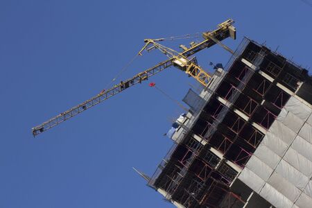 Yellow crane on building  with blue sky