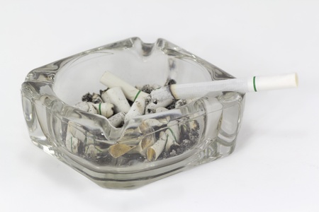 Ashtray and cigarettes on white background