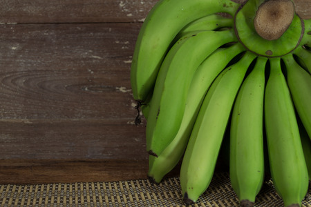 green banana on wood の写真素材