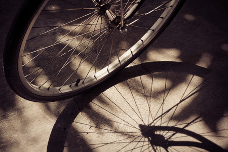 vintage bicycle wheel with shadowの写真素材