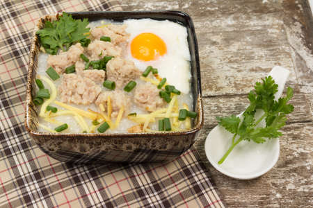 rice porridge with pork and soft boiled eggの写真素材