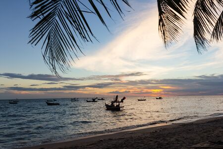 fishing boat on the sea with sunset timeの写真素材