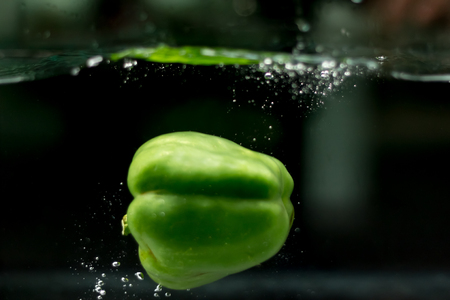bell pepper drop in the waterの写真素材