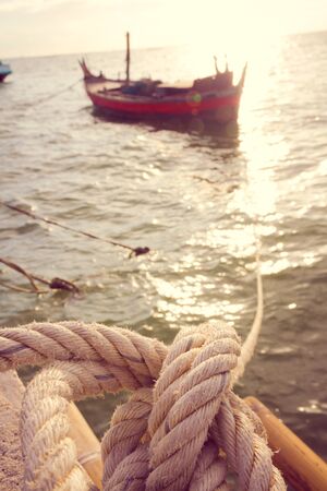 Fishing boat with mooring rope at pier