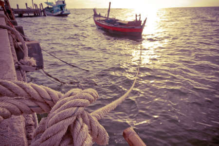 Fishing boat with mooring rope at pierの写真素材
