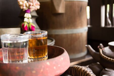 close up glass of water and tea in wooden tray
