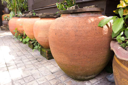 Water jar ancient style on the groundの写真素材