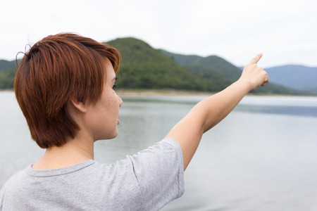tourist woman pointing at destinstion.の写真素材