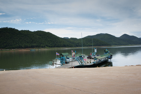 Kanchanaburi - AUG 15,2015: A passenger and car ferry departs at The Sri Nakarin Damのeditorial素材