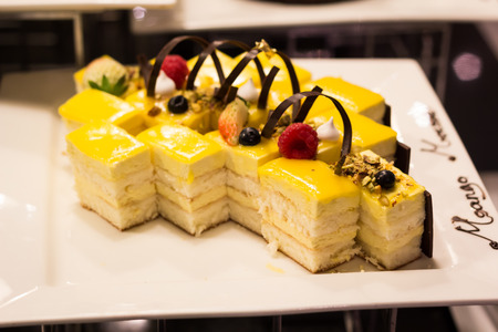 Square Mango Mousse Cake on the Plateの写真素材