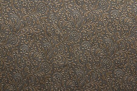 Golden floral ornament pattern on dark  background