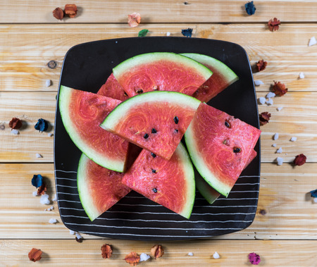 Fresh watermelon slice on wood background