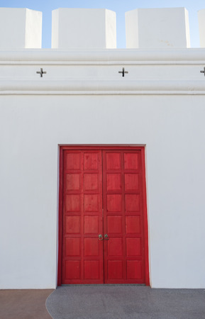 Big red gate to entrance and white wallの写真素材