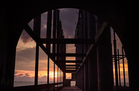 abandon buildings in the sea with sunsetの写真素材