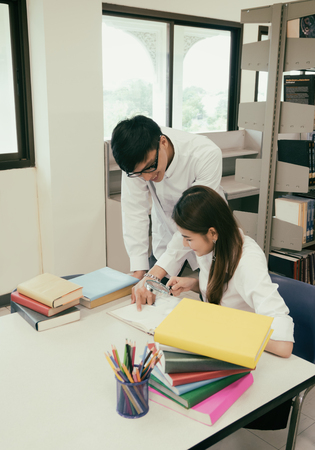student reading book in the libraryの写真素材