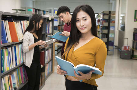 student reading book in University libraryの写真素材