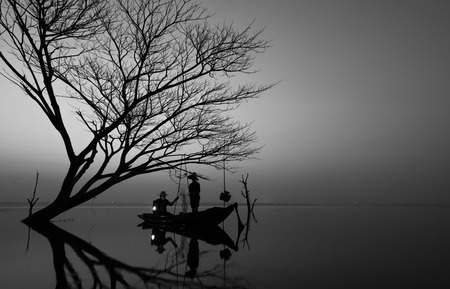 Fishermen prepare to catch fish at the Bangpra lake during sunrise time.の写真素材