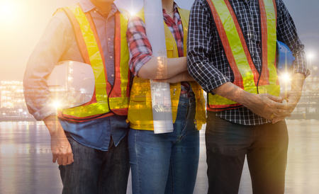 Double exposure of Group of engineer people working on Industrial site backgroundの写真素材