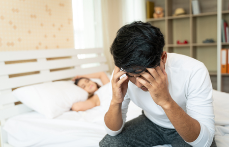 Unhappy family couple having conflict in bedroom at home.の写真素材