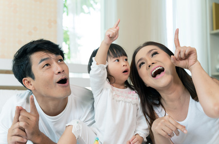 Happy family enjoy and relaxing in bedの写真素材