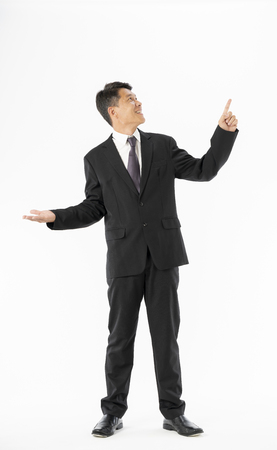 Business man in black suit standing and open hand to copyspace on white backgroundの写真素材