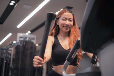 Asian woman with fitness suit exercise in GYM