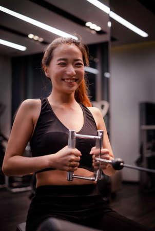 Asian woman with fitness suit exercise in GYMの写真素材