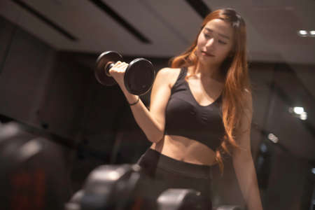 Asian woman with fitness suit exercise in GYMの写真素材