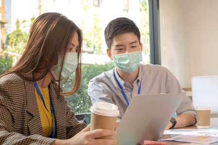 Team of business partner hot discussion and brainstorm about Ux Ui app design to achieve success in their start-up business.の写真素材