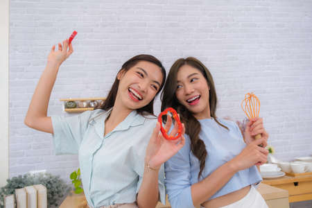 Young Asian couple feel happy with LGTB Flag backgroundの写真素材