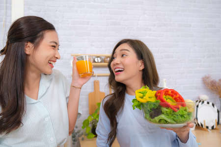 Young Asian couple feel happy with LGTB Flag backgroundの写真素材