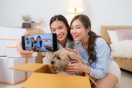 Young Asian couple women enjoy to cooking salad at home.
