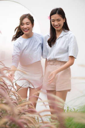 Young Asian couple women enjoy to cooking salad at home.