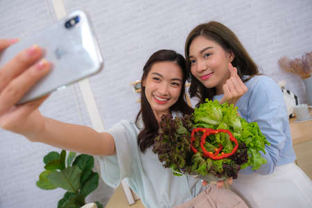 Couple Asian women be happy to in new house with her dogの写真素材