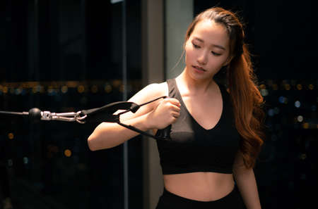 Asian woman with fitness suit exercise in GYMの写真素材