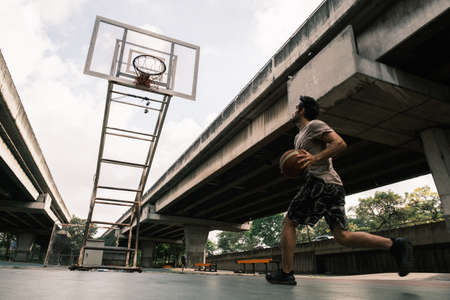 Young causian basketball player resting and ralax.