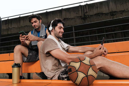 Two causian basketball player resting and ralax.