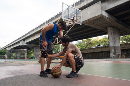 Young man basketball player injury from playing basketball